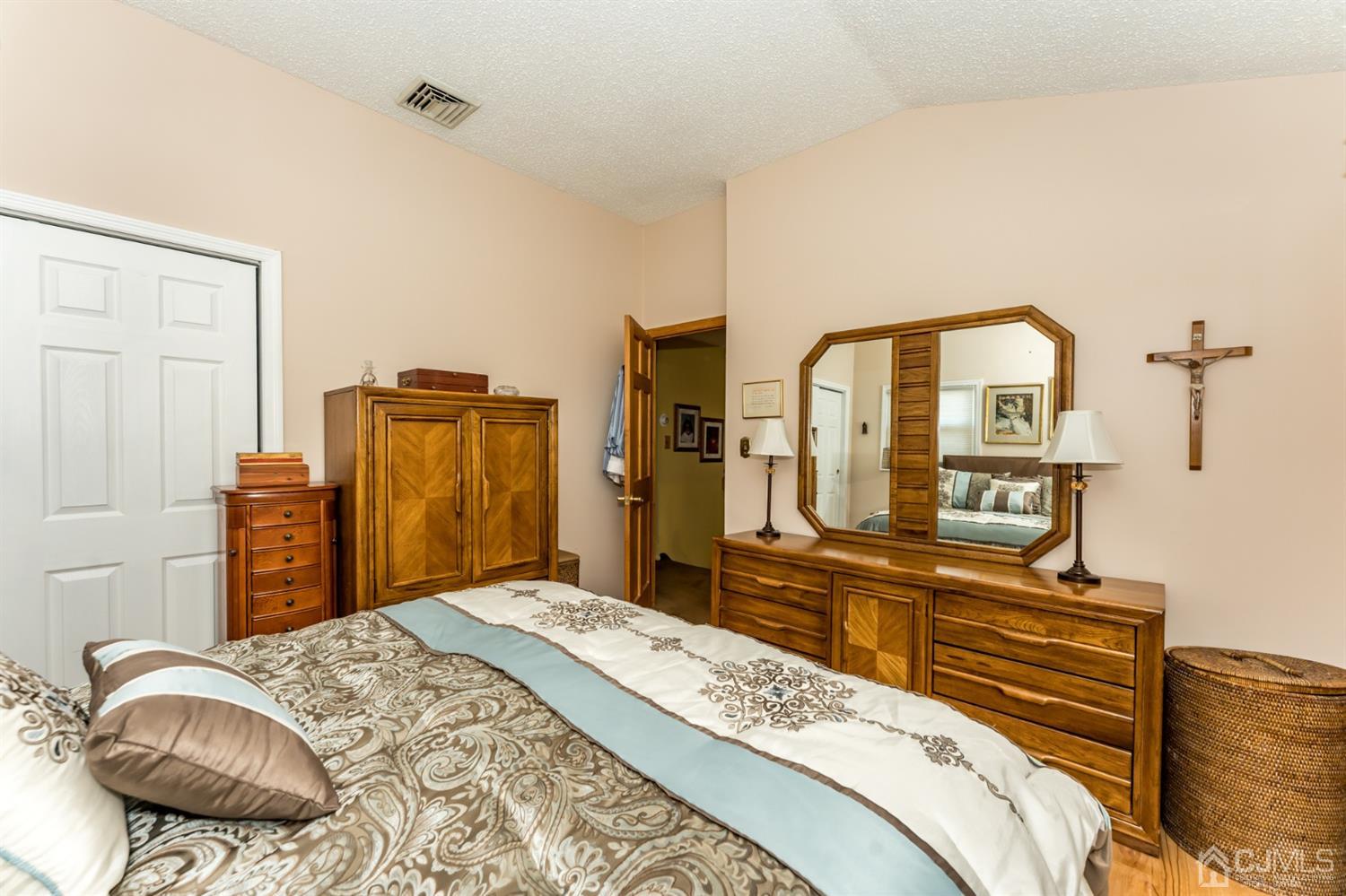 41 Trafalgar Drive Colonia, NJ 07067 - Photo 19 of 40 a bedroom with a bed and dresser with mirror