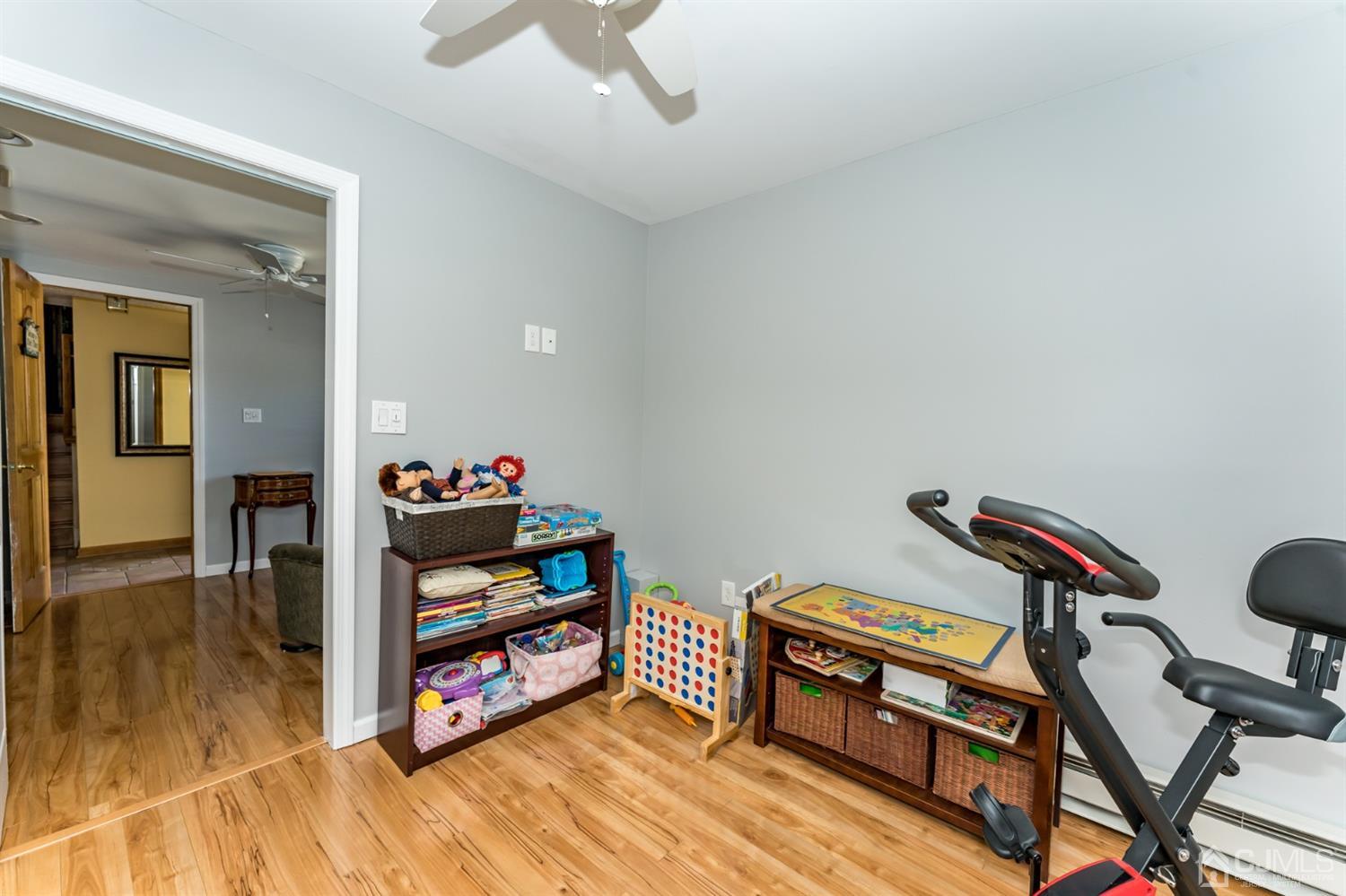 41 Trafalgar Drive Colonia, NJ 07067 - Photo 28 of 40 a living room with a piano and wooden floor