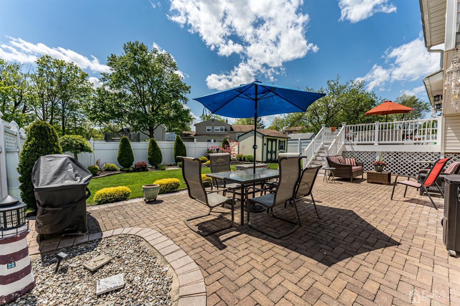 41 Trafalgar Drive Colonia, NJ 07067 - Photo 36 of 40 a view of a patio with a table and chairs under an umbrella