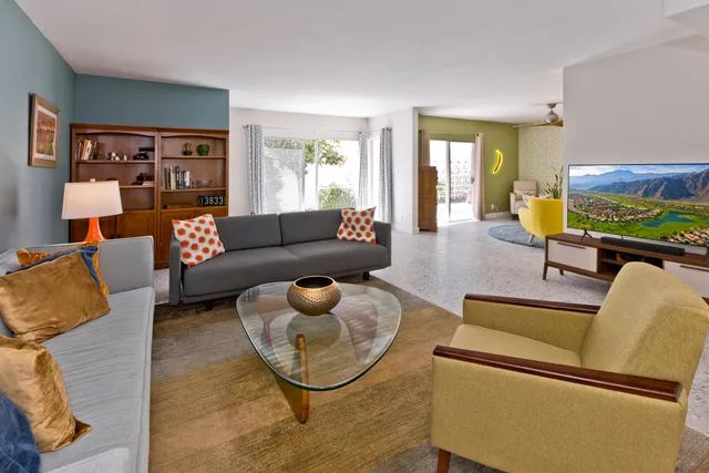 a view of a livingroom with a ceiling fan and window