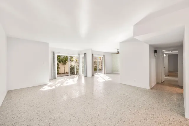 a kitchen with a sink refrigerator and cabinets
