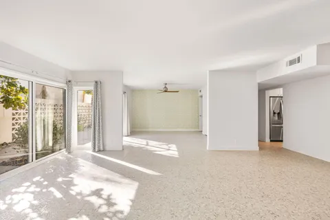 a view of a kitchen that has a sink and a window