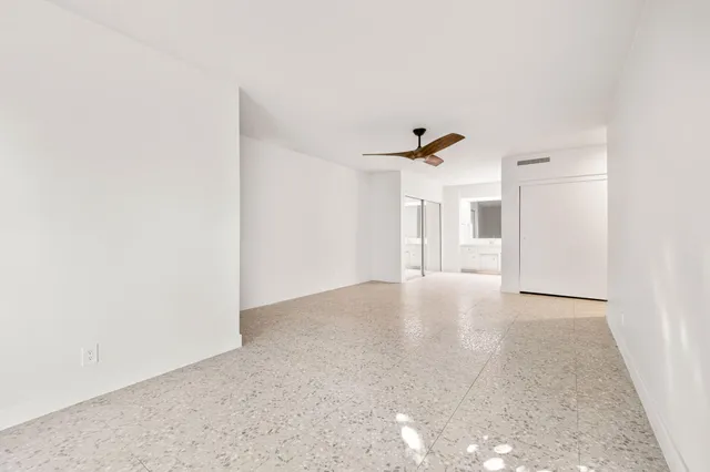 a view of a house with a yard and potted plants