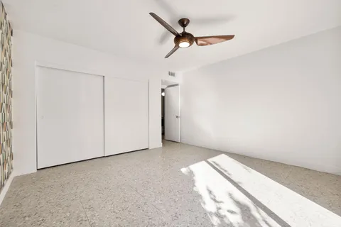 a view of a kitchen with white cabinets and a stove top oven