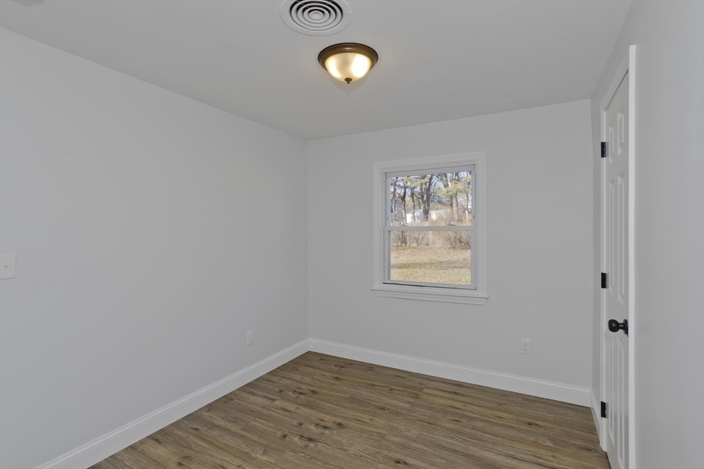 118 Keddy Street Springfield, MA 01109 - Photo 12 of 19 an empty room with wooden floor and windows