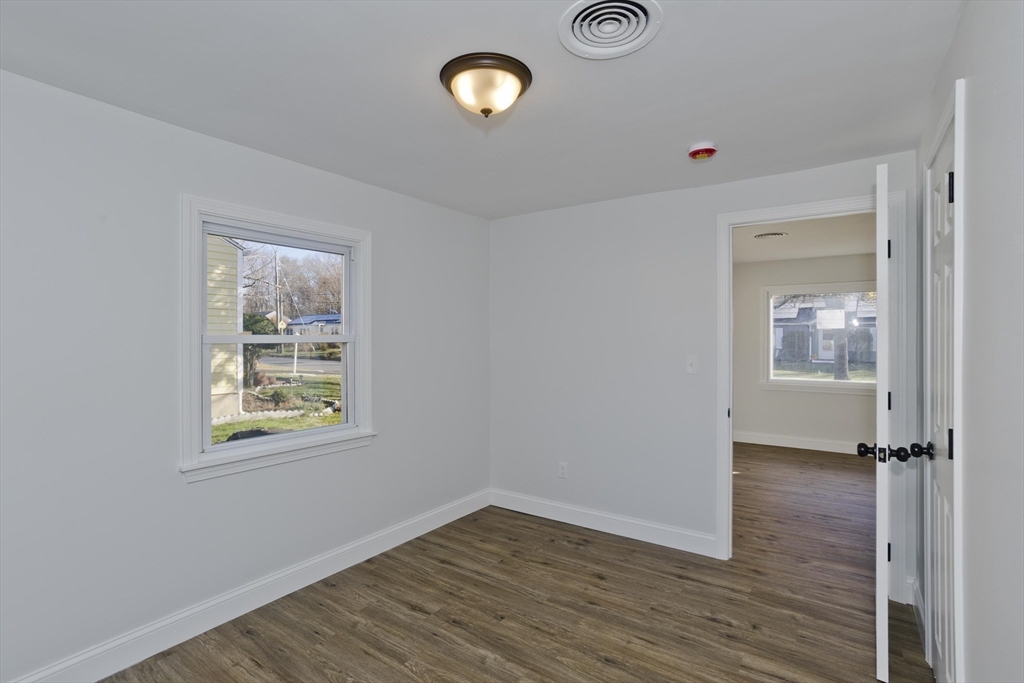 118 Keddy Street Springfield, MA 01109 - Photo 16 of 19 an empty room with wooden floor and a window