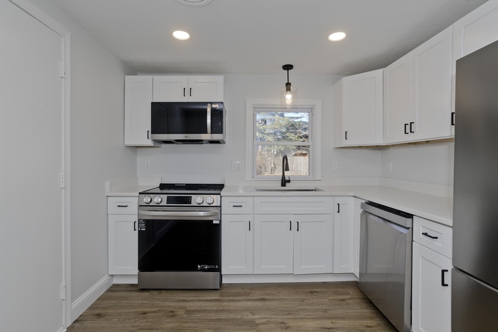 118 Keddy Street Springfield, MA 01109 - Photo 5 of 19 a kitchen with stainless steel appliances granite countertop a stove and a sink