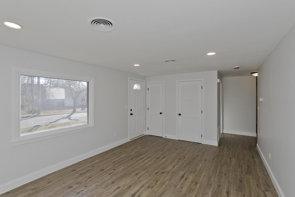 118 Keddy Street Springfield, MA 01109 - Photo 8 of 19 a view of an empty room with wooden floor and a window