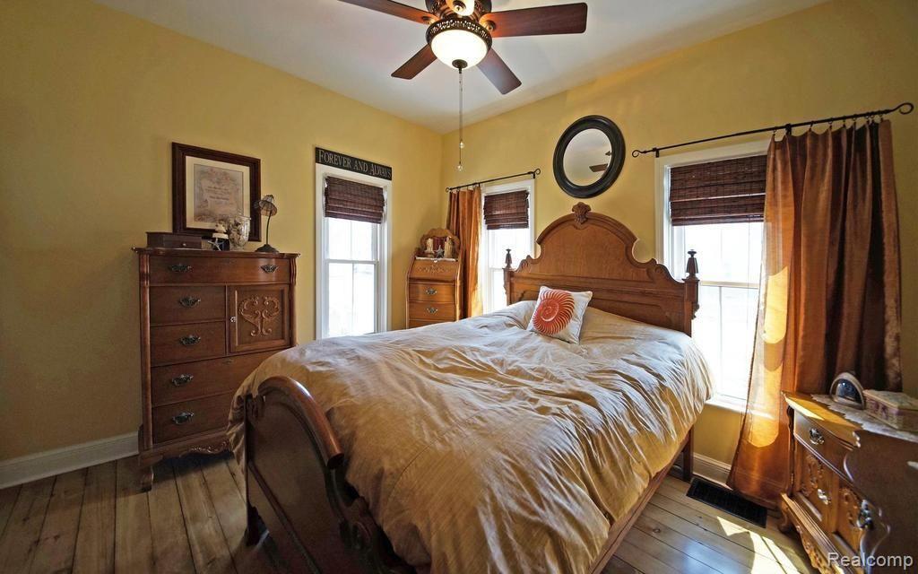 1451 Butler Boulevard Howell, MI 48843 - Photo 15 of 26 Master bedroom has multiple windows to let in light giving it a sunny cozy charm.