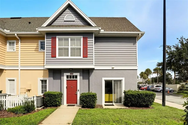 a front view of a house with a yard and plants