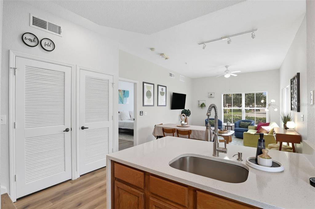 2606 Lodi Circle, Unit 102 Kissimmee, FL 34746 - Photo 12 of 37 a kitchen with stainless steel appliances granite countertop a sink and dishwasher with wooden floor