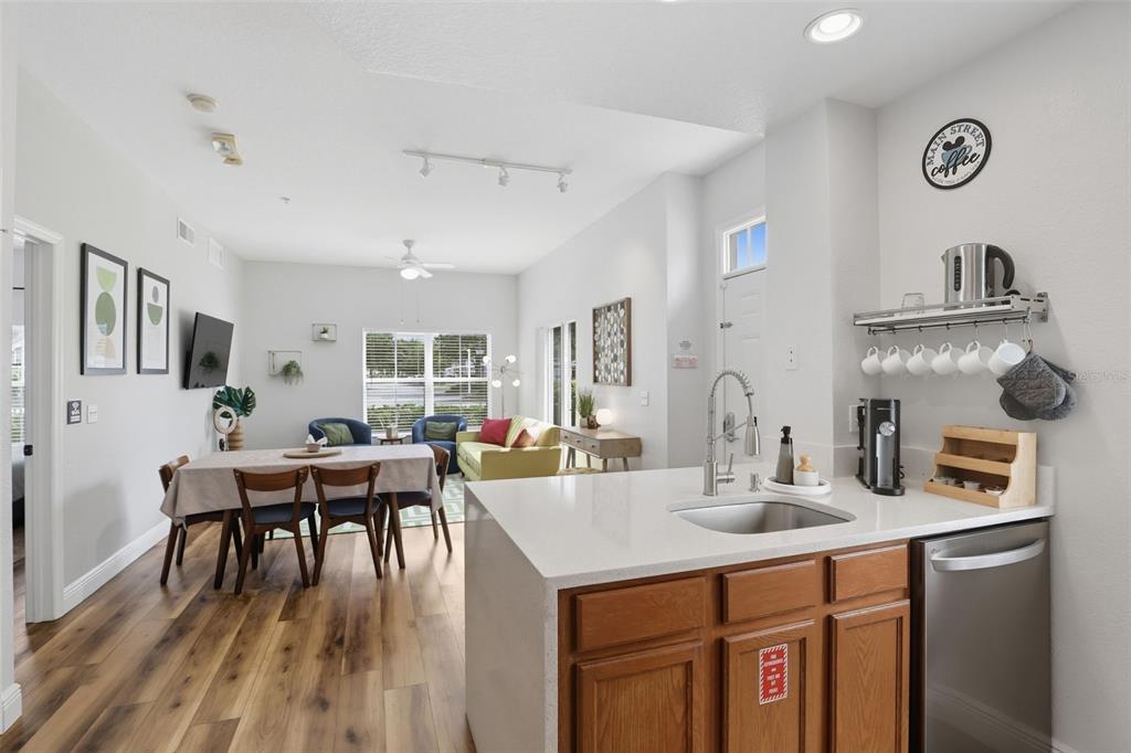 2606 Lodi Circle, Unit 102 Kissimmee, FL 34746 - Photo 13 of 37 a kitchen with a dining table chairs and white cabinets