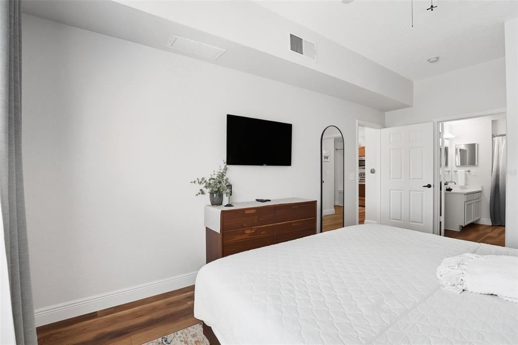 2606 Lodi Circle, Unit 102 Kissimmee, FL 34746 - Photo 16 of 37 a bedroom with a bed and a flat screen tv