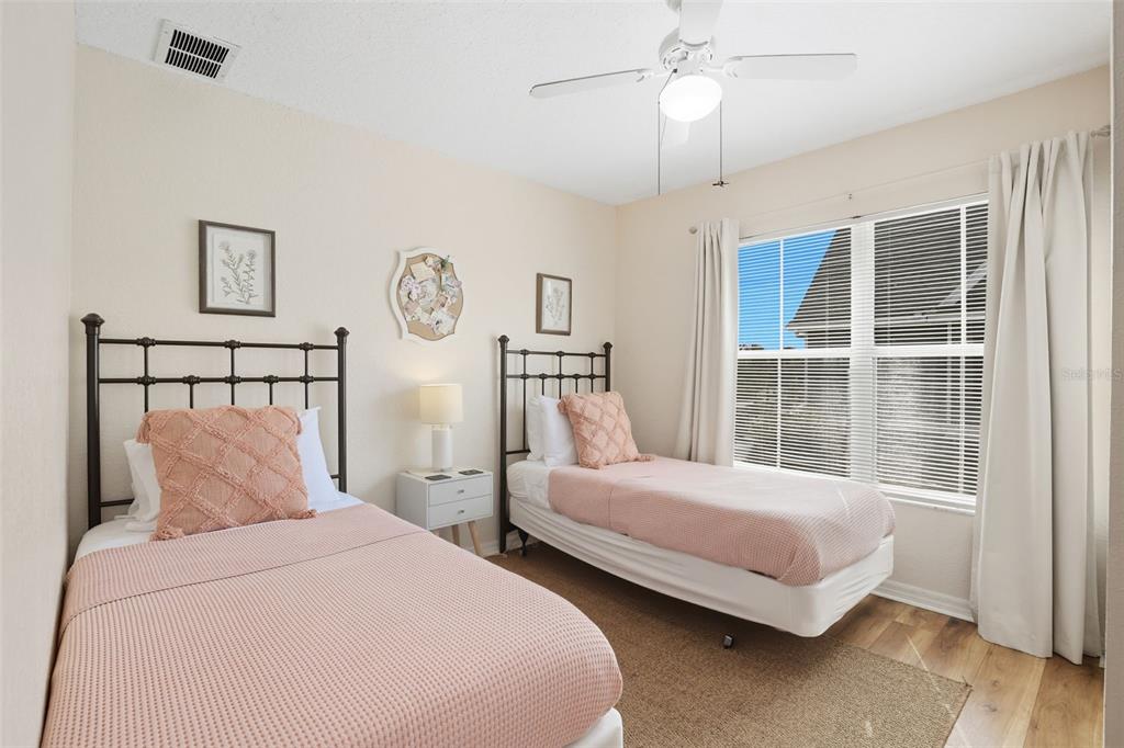 2606 Lodi Circle, Unit 102 Kissimmee, FL 34746 - Photo 25 of 37 a bedroom with two beds and a window