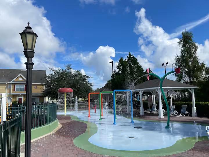 2606 Lodi Circle, Unit 102 Kissimmee, FL 34746 - Photo 33 of 37 a front view of a house with garden
