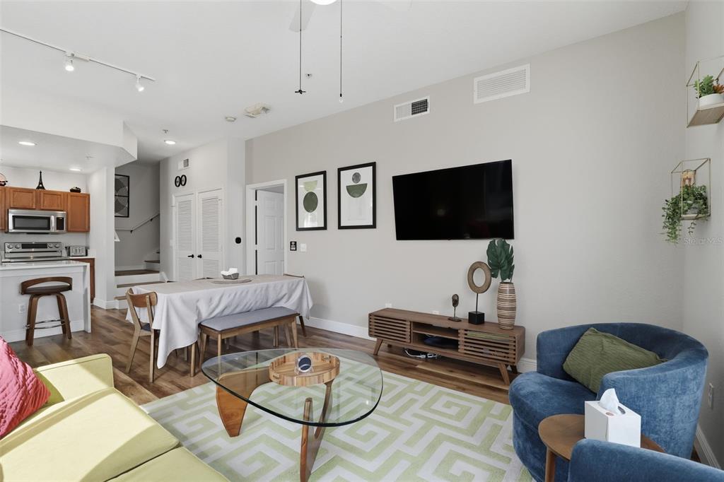 2606 Lodi Circle, Unit 102 Kissimmee, FL 34746 - Photo 8 of 37 a living room with furniture and a flat screen tv