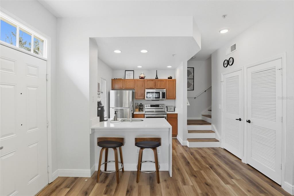 2606 Lodi Circle, Unit 102 Kissimmee, FL 34746 - Photo 9 of 37 a view of a kitchen with dining table and chairs