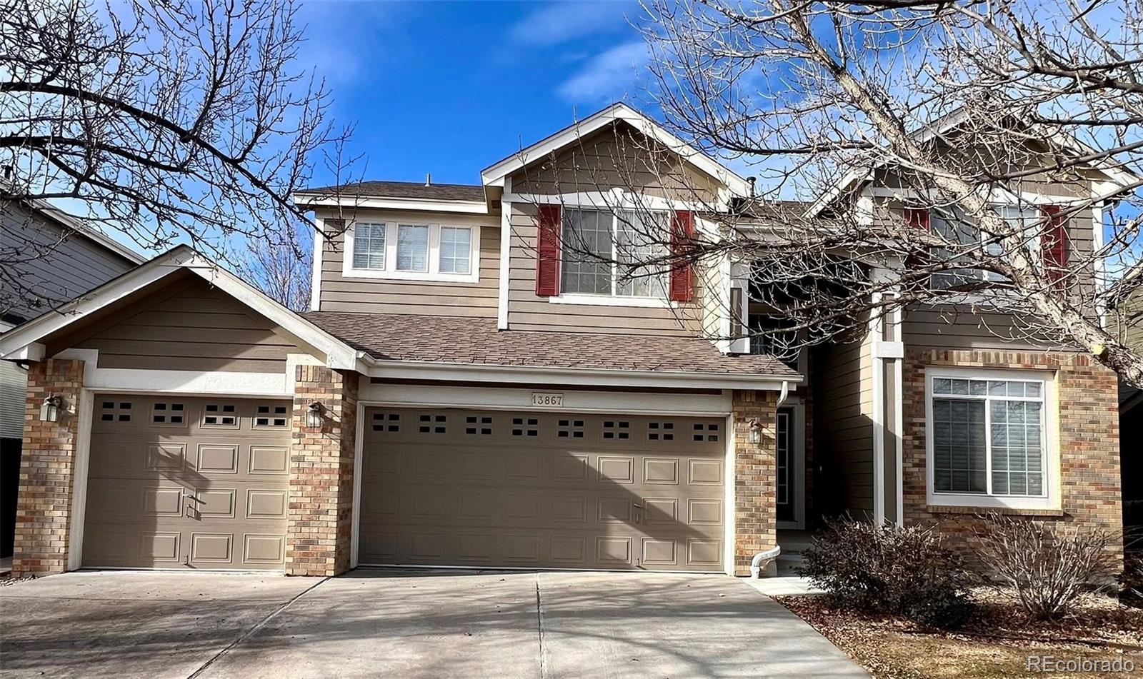 13867 Fillmore Street Thornton, CO 80602 - Photo 1 of 24 a front view of a house with a yard