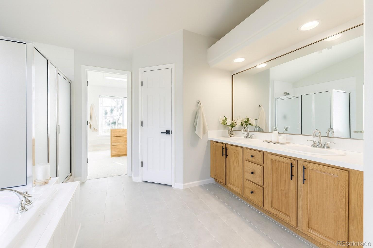 13867 Fillmore Street Thornton, CO 80602 - Photo 12 of 24 a bathroom with a double vanity sink mirror and double