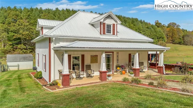 a view of a house with furniture and garden