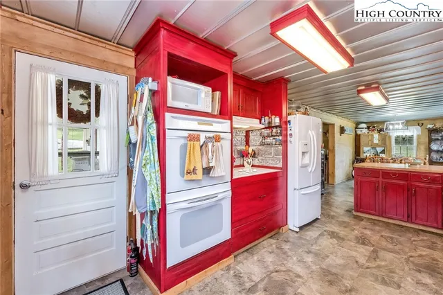 a kitchen with stainless steel appliances granite countertop wooden cabinets sink and cabinets