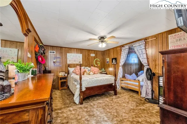 a view of backyard of house with wooden fence