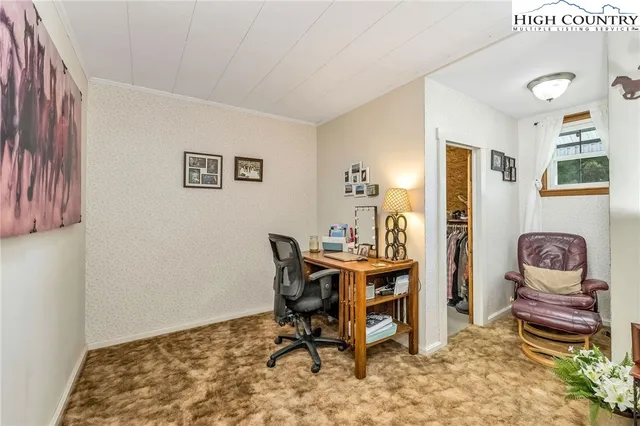 a living room with furniture and a kitchen view
