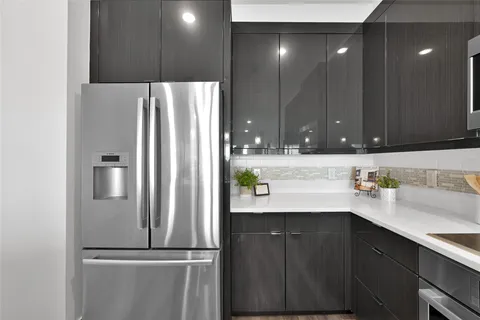 a kitchen with a refrigerator and cabinets