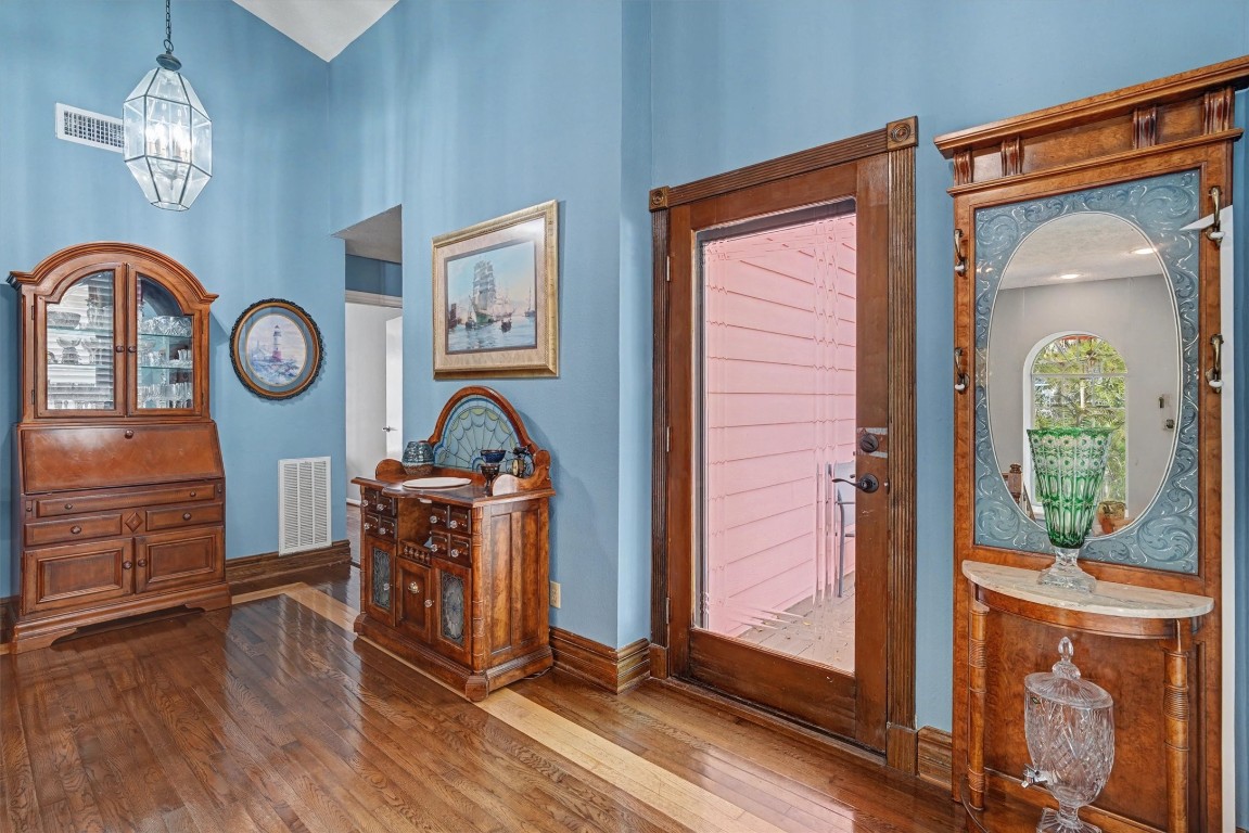 2205 Mission Street Kemah, TX 77565 - Photo 15 of 33 a view of a hallway with entryway wooden floor windows and a fireplace