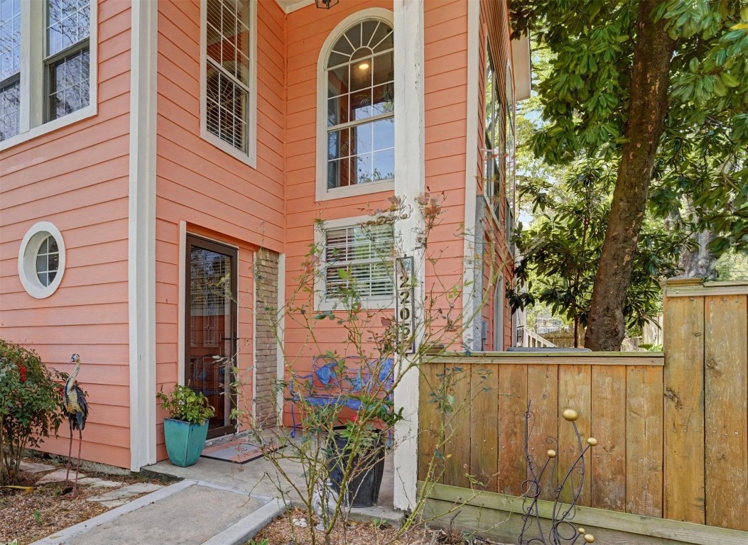 2205 Mission Street Kemah, TX 77565 - Photo 2 of 33 a view of a brick house with a large windows and flower plants