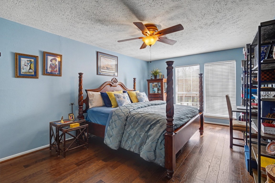2205 Mission Street Kemah, TX 77565 - Photo 21 of 33 a bedroom with a bed and wooden floor