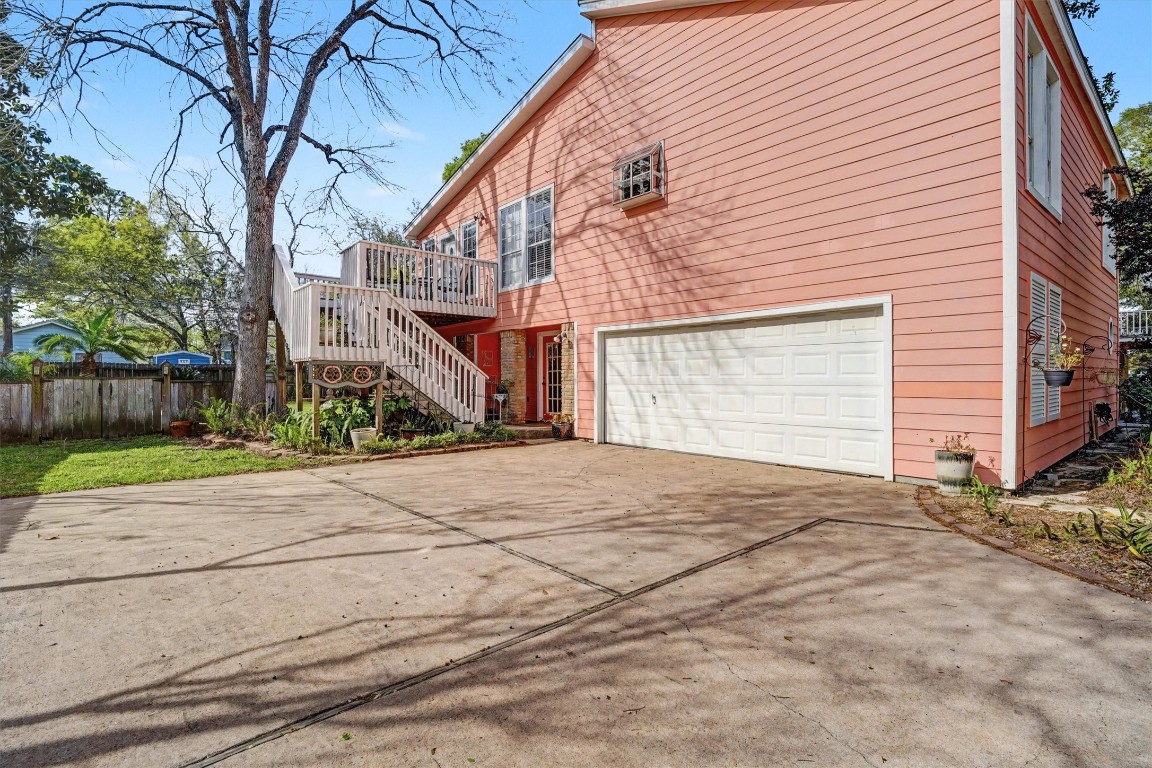 2205 Mission Street Kemah, TX 77565 - Photo 29 of 33 Rear exterior view of the home showcasing the elevated design, multiple decks, and attached two-car garage with plenty of room to park an RV and/or boat.