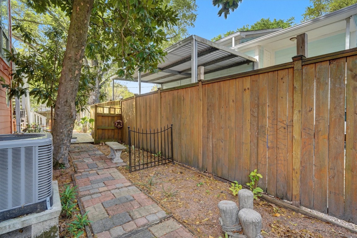 2205 Mission Street Kemah, TX 77565 - Photo 30 of 33 a backyard of a house with potted plants and large tree