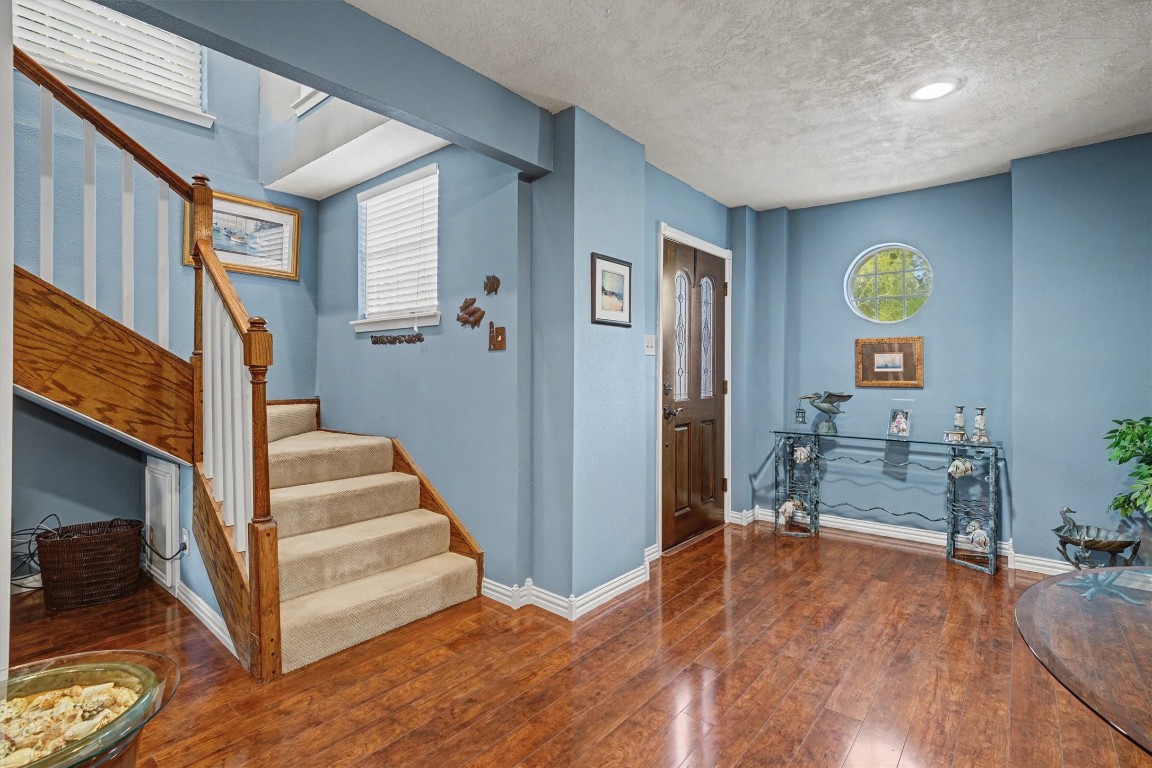 2205 Mission Street Kemah, TX 77565 - Photo 3 of 33 Welcoming foyer with beautiful flooring and staircase leading to the main living area located on the second floor.