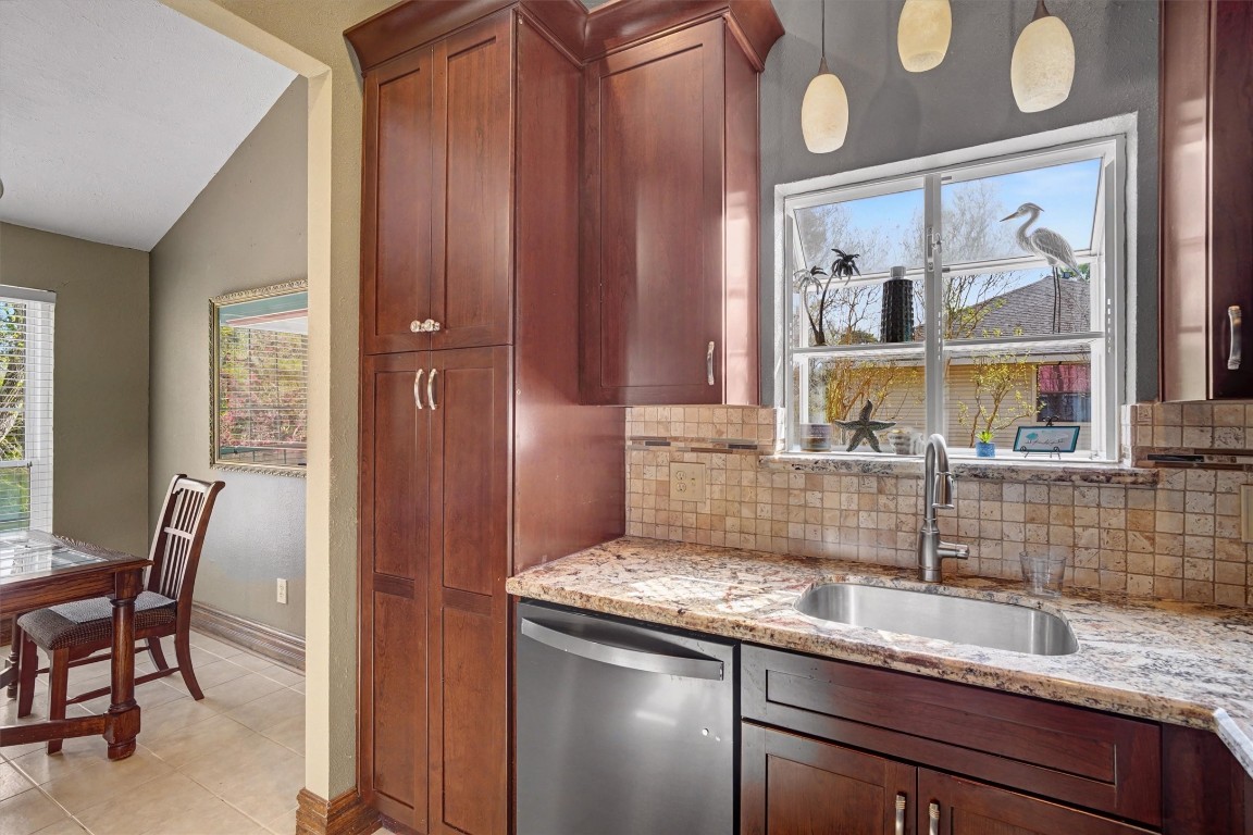 2205 Mission Street Kemah, TX 77565 - Photo 9 of 33 a kitchen with stainless steel appliances granite countertop a sink and a window