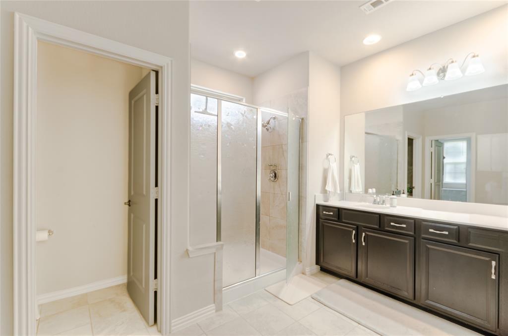 1448 Pebble Way Allen, TX 75013 - Photo 12 of 25 a bathroom with a shower sink and mirror