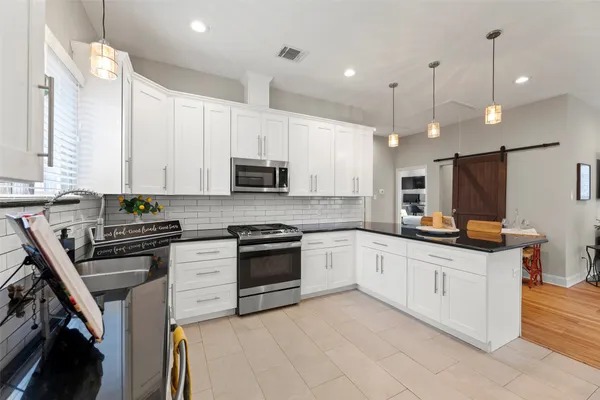 a kitchen with a dining table and chairs