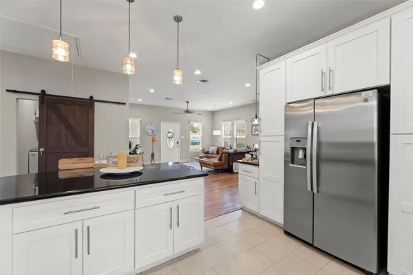 a kitchen with stainless steel appliances a stove sink microwave and cabinets