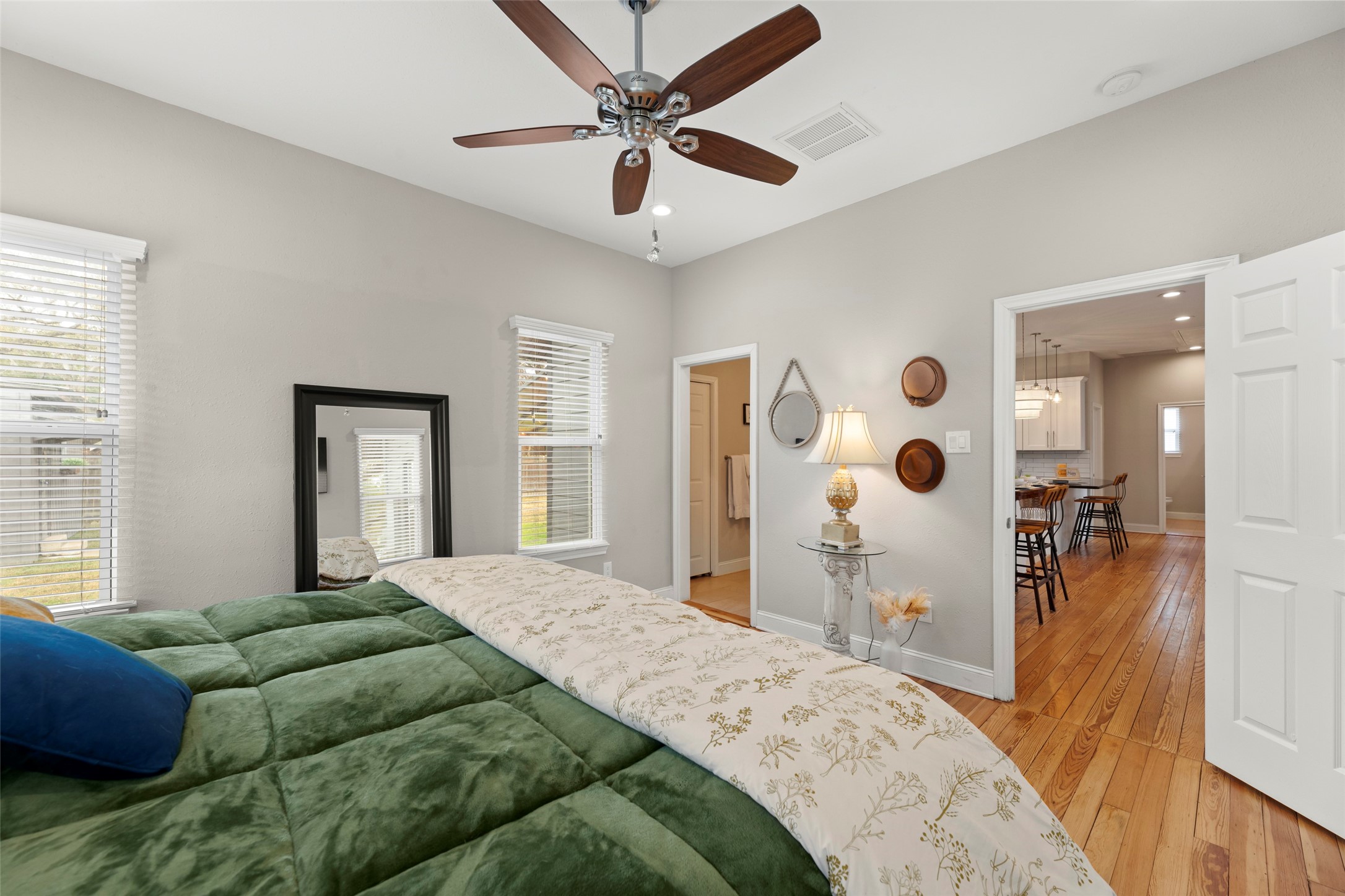 711 4th Street Sealy, TX 77474 - Photo 19 of 37 a bedroom with a bed and a large mirror with a flat tv screen