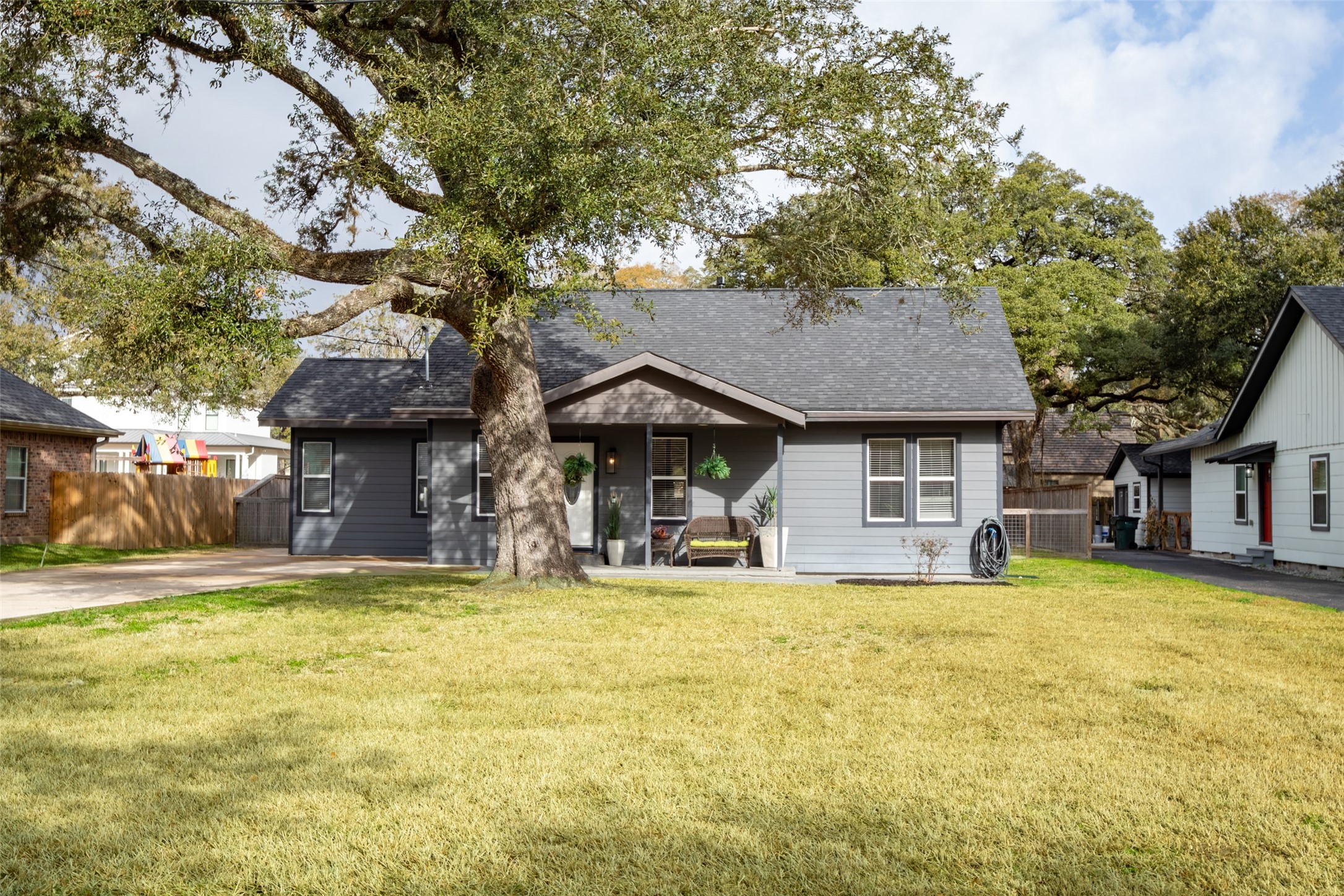 711 4th Street Sealy, TX 77474 - Photo 2 of 37 a view of a house with swimming pool and a chairs and table in a patio