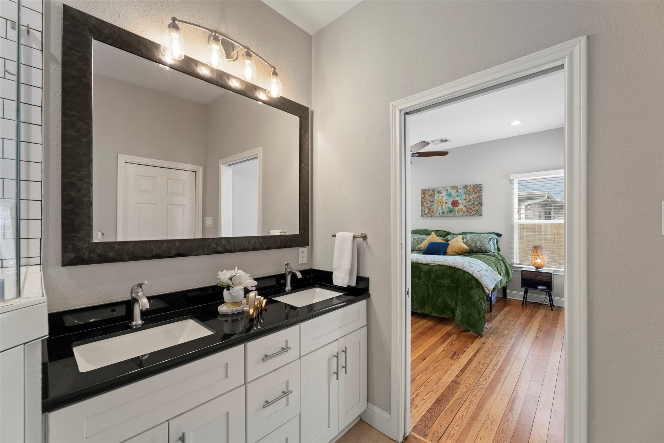 711 4th Street Sealy, TX 77474 - Photo 21 of 37 a en suite spacious bathroom with a double vanity sink and a mirror