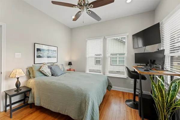 a bedroom with a bed and a desk