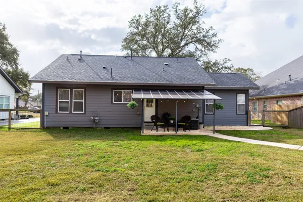 a front view of house with yard and trees