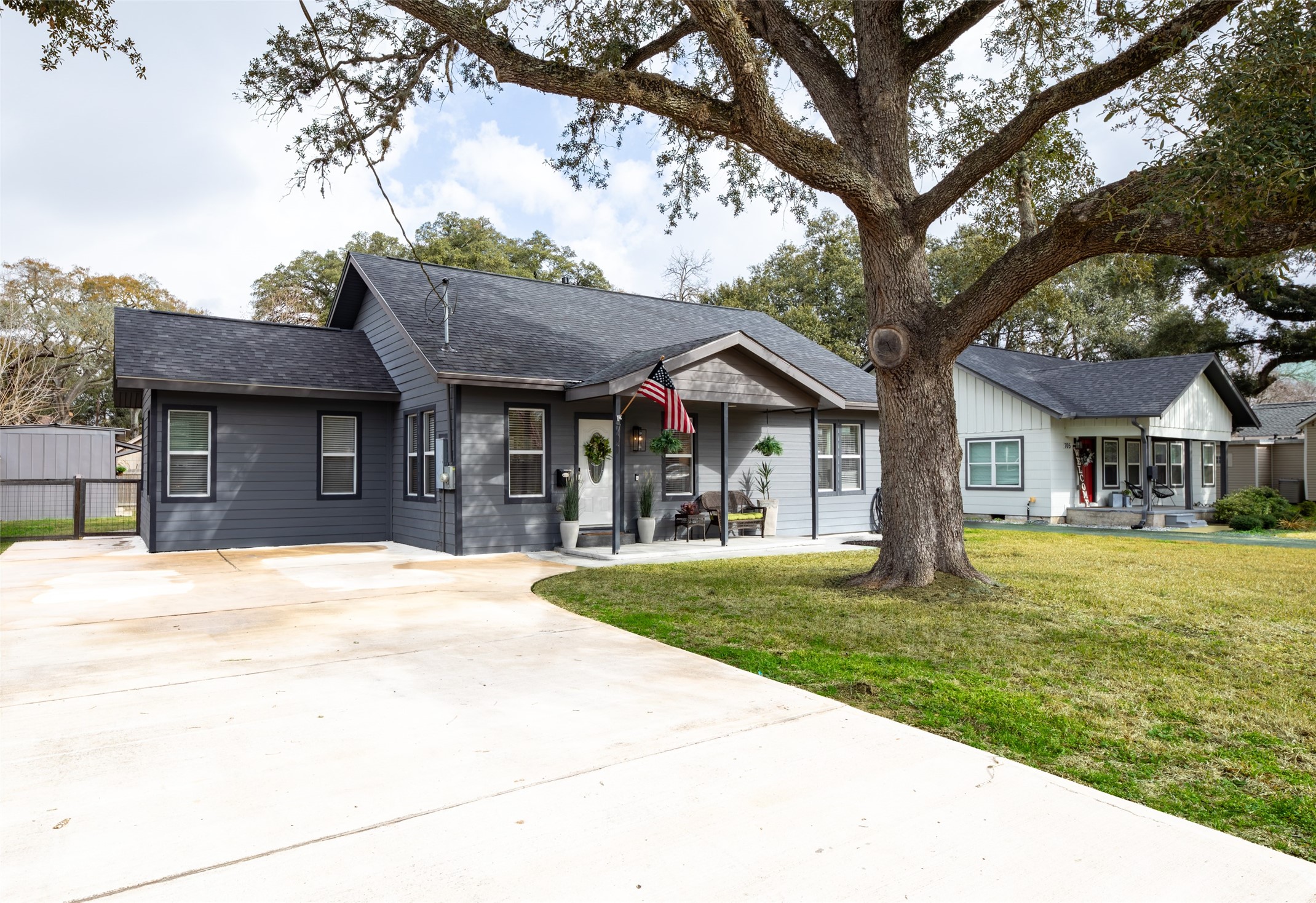 711 4th Street Sealy, TX 77474 - Photo 4 of 37 a front view of a house with a garden and trees