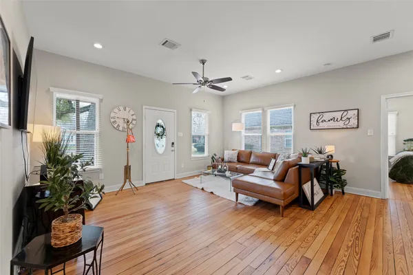 a living room with furniture and wooden floor