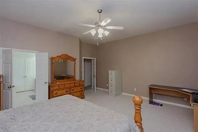 a en suite bathroom with a granite countertop sink and a mirror