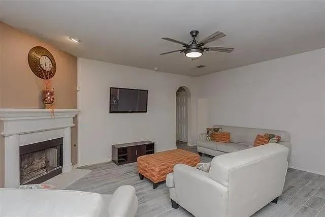 a living room with furniture and a fireplace