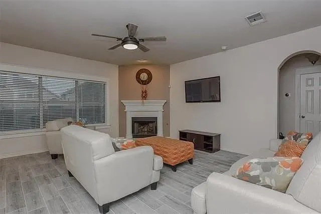 a living room with furniture and a fireplace