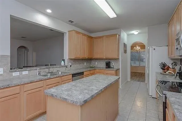 a kitchen with a sink and cabinets