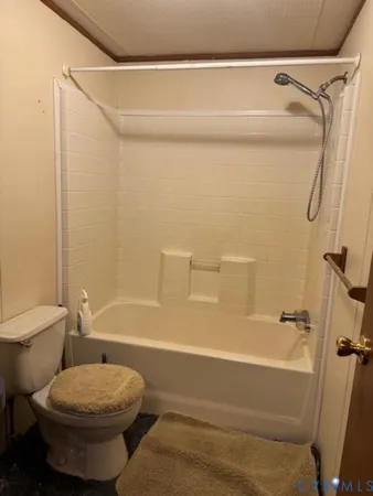 a bathroom with a toilet and a bathtub